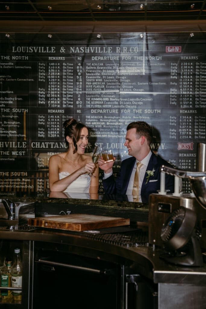 Wedding couple embracing at Nashville venue with photographer