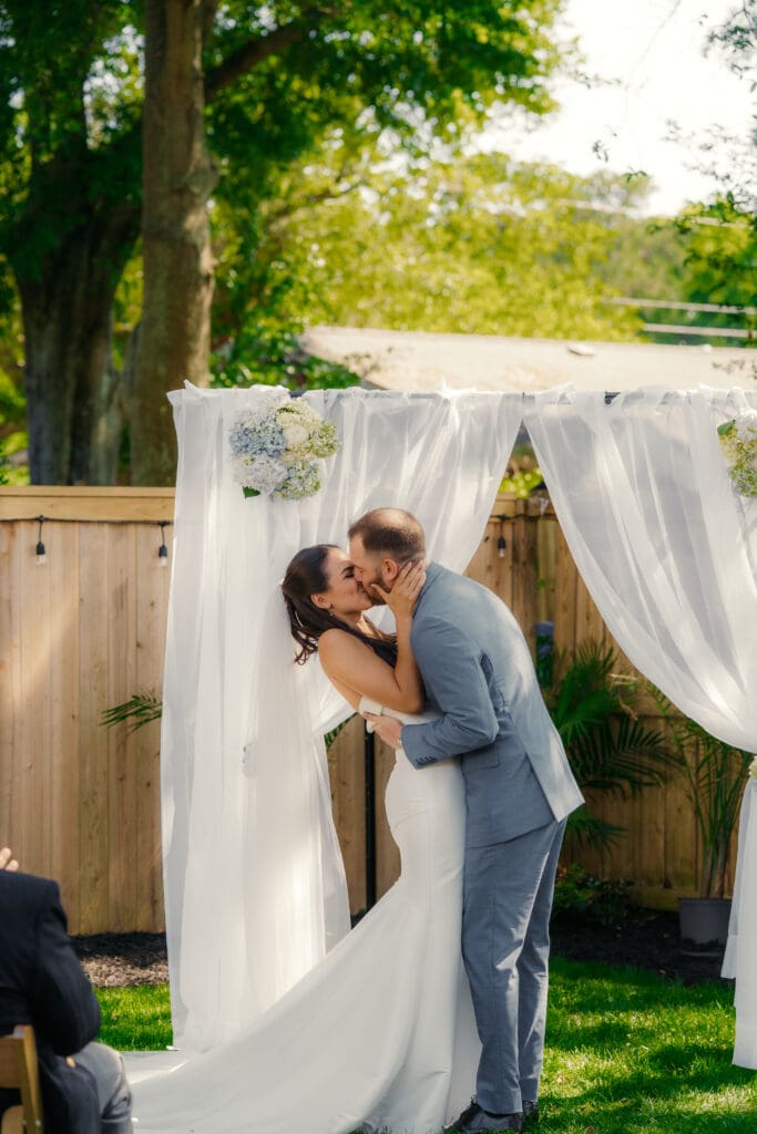First kiss at the ceremony for a bride and groom
