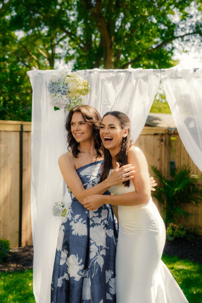 Mother Daughter embrace before family photos of their wedding day