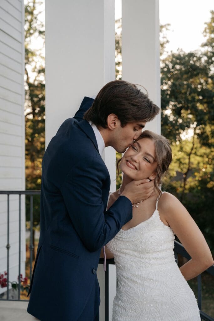 Groom playfully kisses his bride after their wedding ceremony
