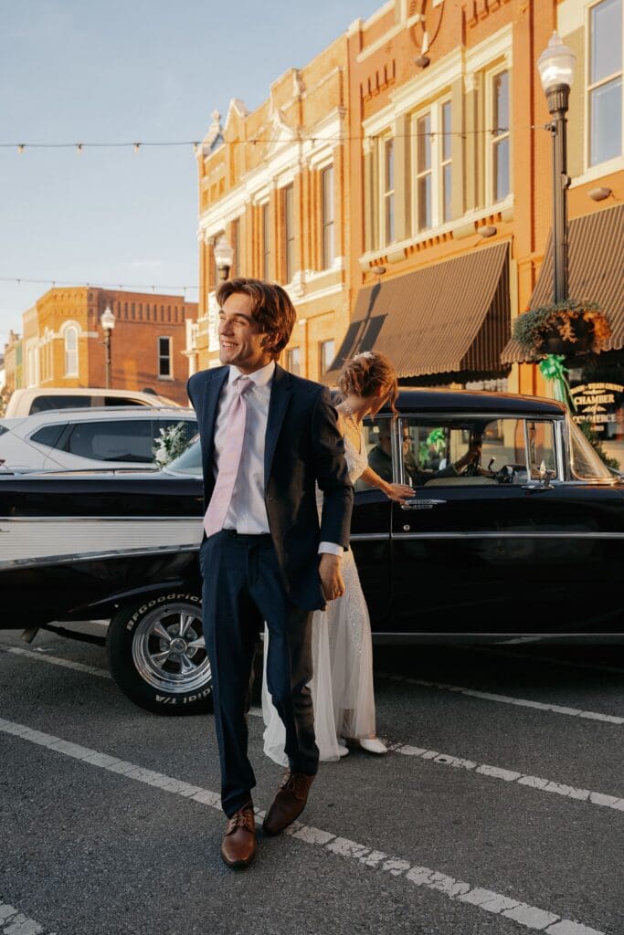 Groom leading his bride into their wedding reception 