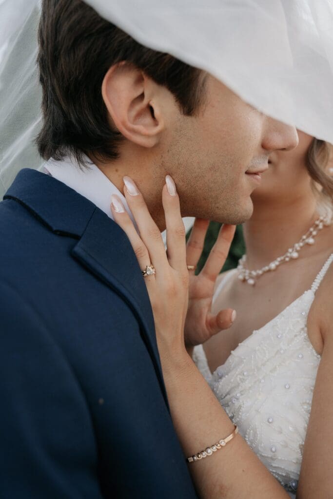 Bride and Groom whisper to each other while taking pictures of their Nashville Wedding