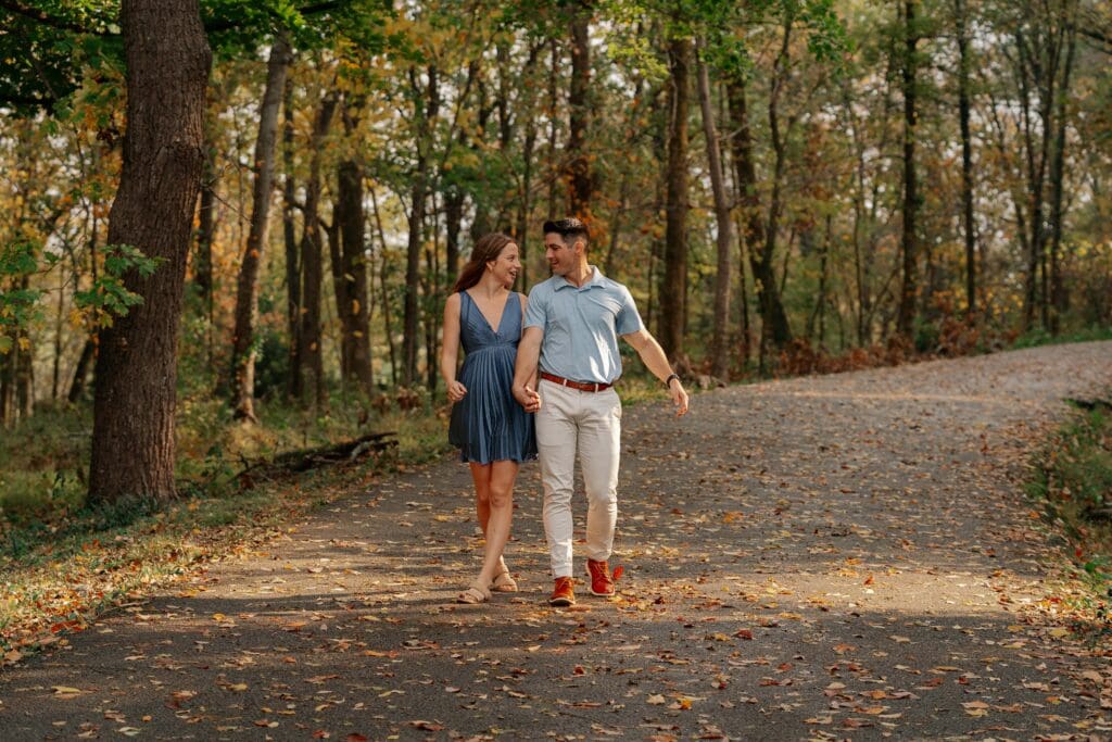 Newly engaged couple walking hand in hand at Percy Warner Park