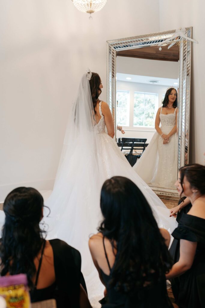 Bridemaids helping adjust brides dress before the ceremony at Graystone Quarry