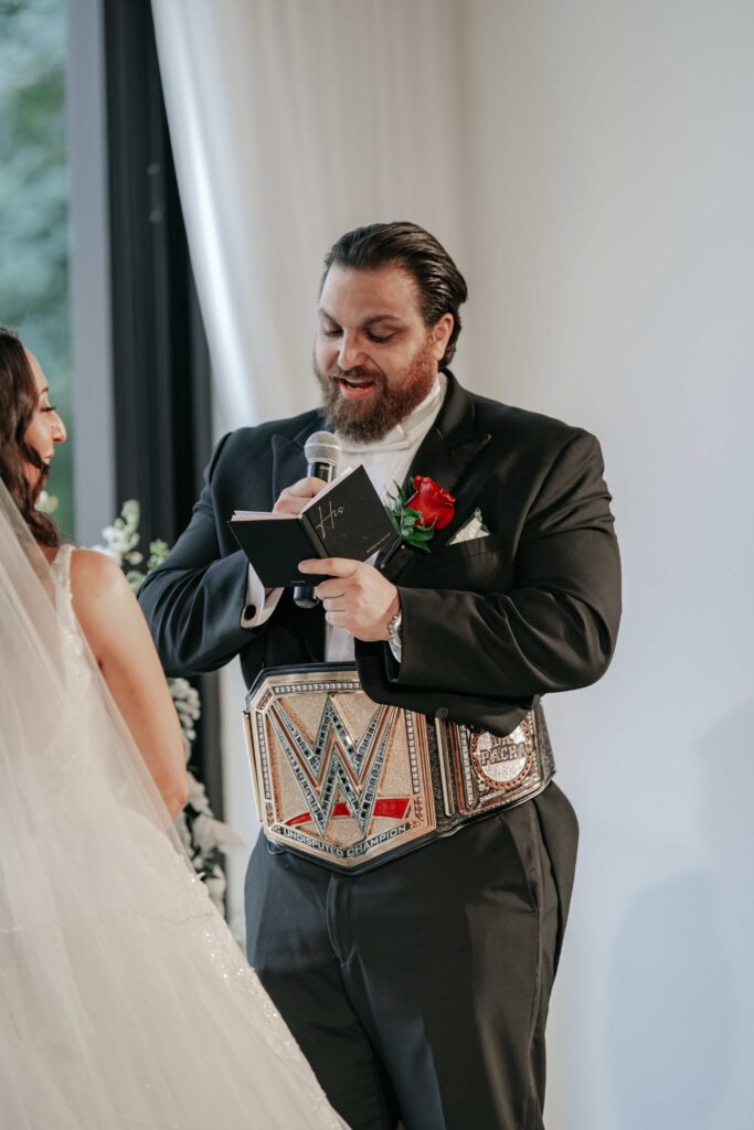 Groom put on his custom WWE wrestling belt during his vows of a Nashville TN wedding
